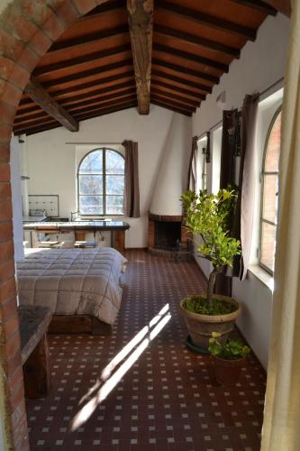 a bedroom with a bed and a table in a room at La Limonaia di Casagrande in Barga