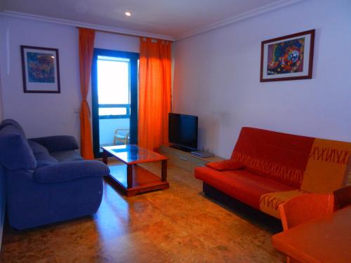 a living room with a couch and a tv at Apartment Valencia in Valencia