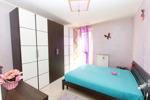 a bedroom with a blue bed in a room at WINE & LAKE IN FRANCIACORTA in Passirano