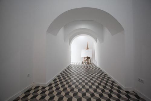 an empty hallway with a table and a lamp at Place Of Moments Urban-Suites in Ponta Delgada