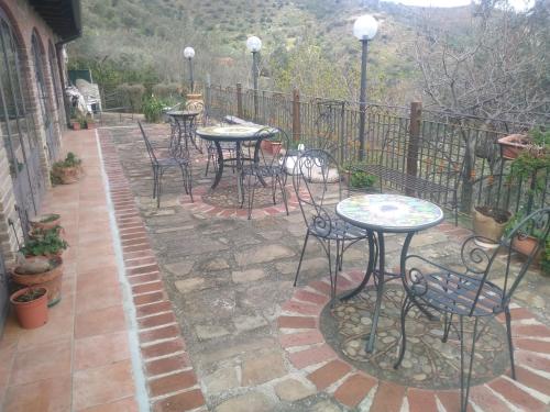 a group of tables and chairs on a patio at L'Uliveto in Reitano