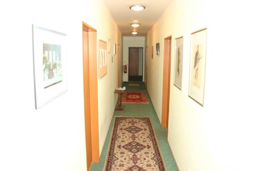 a hallway with rugs on the walls and a hallway at Penzion Pohoda in Lultsch