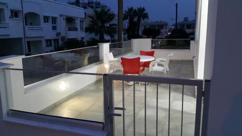 a balcony with a table and chairs on a building at CHRIS'S HOLIDAY APT - AYIA NAPA in Ayia Napa