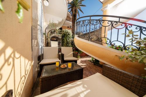 a balcony with a table and chairs on a building at Apartment Villa Marija in Tivat