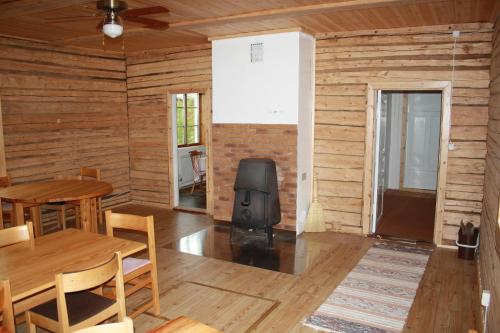 a dining room with a table and a television at Old timber house in Kalix