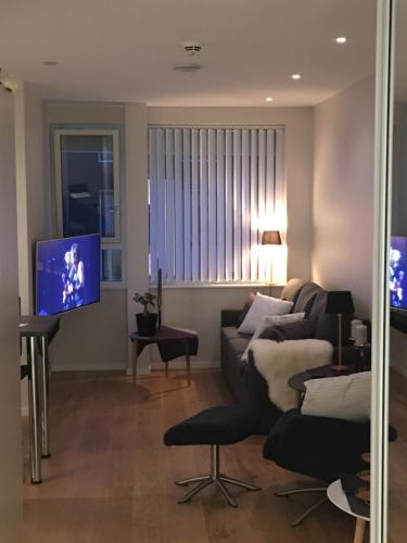 a living room with a couch and a flat screen tv at Førde in Førde