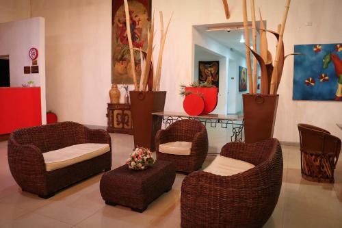 a room with wicker chairs and a table at Zar Colima in Colima
