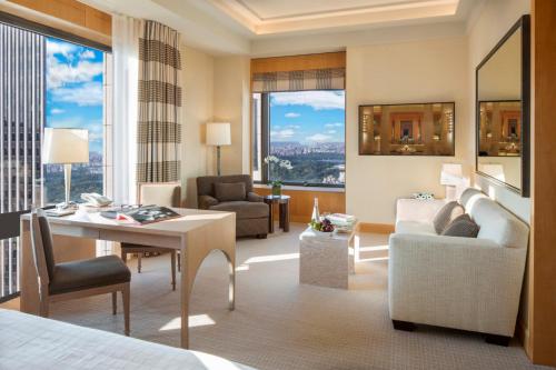 a hotel room with a bed and a desk and chair at Four Seasons Hotel New York in New York