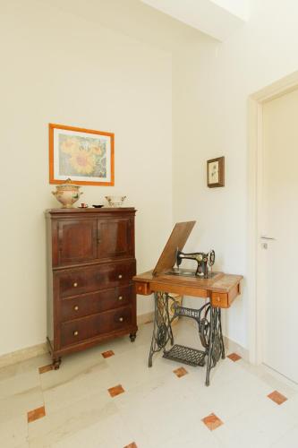 a room with a wooden desk and a dresser at La Terrazza sul Mare in Cefalù