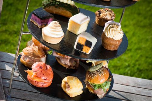 a three tiered tray with different pastries on it at Bunchrew House Hotel in Inverness