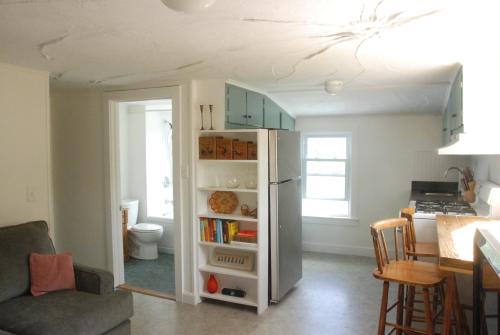 a kitchen with a refrigerator and a table at The Harwood Hill in Bennington
