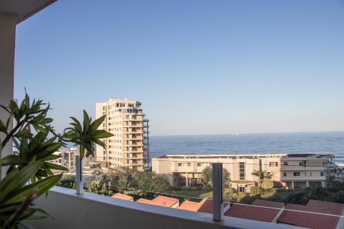 a view of the ocean from the balcony of a building at 34 Sea Lodge - by Stay in Umhlanga in Durban