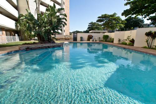 a swimming pool with blue water in a building at 34 Sea Lodge - by Stay in Umhlanga in Durban