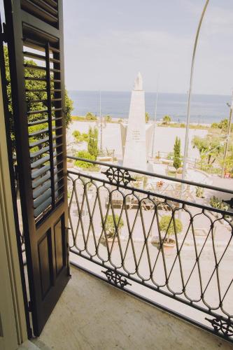an open door to a balcony with a view of the ocean at Pandora in Porticello