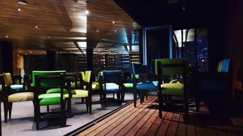a group of chairs and tables in a room at G1 Lodge in Baguio