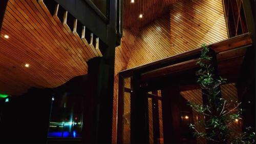 a room with a staircase and a window with a plant at G1 Lodge in Baguio