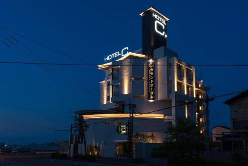 a building with a neon sign on it at night at HOTEL C. KOKURA-BAY (Love Hotel) in Kitakyushu