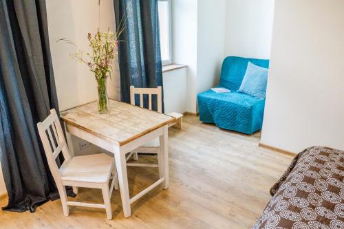a room with a table with a vase of flowers on it at U Čmeláků in Červená Voda