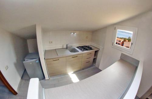 a small kitchen with a sink and a window at Blu Baita in La Maddalena