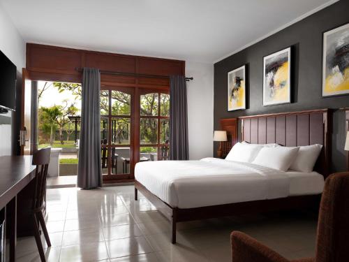 Ένα ή περισσότερα κρεβάτια σε δωμάτιο στο Brits Resort Lovina