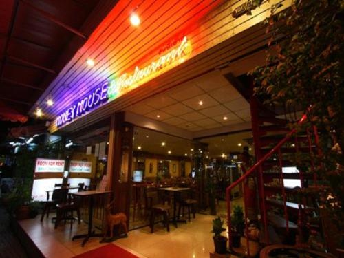 a restaurant with a neon sign on the front of it at Honey House 2 in Bangkok