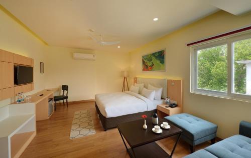 a hotel room with a bed and a couch at 10 Park Street Hotel & Banquets in Gorakhpur
