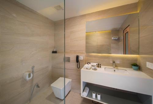 a bathroom with a toilet and a sink and a shower at 10 Park Street Bed & Breakfast in Gorakhpur