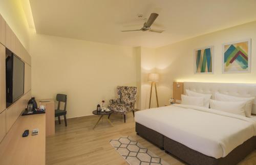 a hotel room with a bed and a tv at 10 Park Street Bed & Breakfast in Gorakhpur