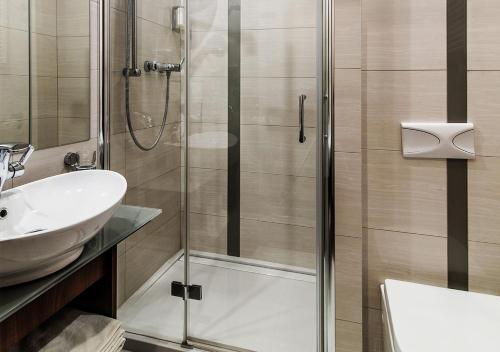 a bathroom with a shower and a sink at Hotel Lord - Warsaw Airport in Warsaw