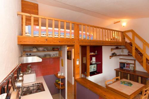 a small kitchen with a loft with a staircase at Porticcio Terra Bella in Porticcio