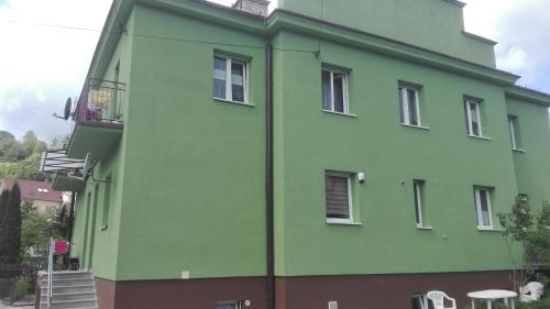 a green building with a staircase on the side of it at Anna in Krynica Zdrój
