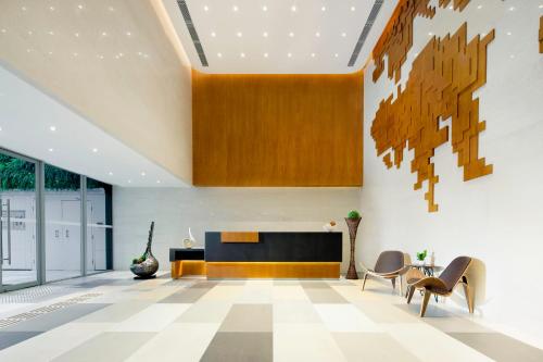 an office lobby with a desk and chairs at Summit View Kowloon in Hong Kong