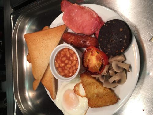 a plate of breakfast food with sausage beans and bread at St Albans Hotel in Blackpool