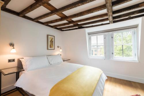 a bedroom with a large bed and a window at ALTIDO Spacious & Chic flat in Angel in London