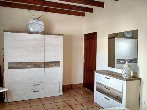 a bedroom with a white dresser and a mirror at Villa Piedra in Playa Blanca