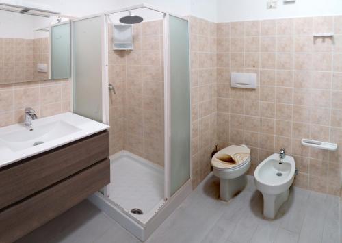 a bathroom with a shower and a toilet and a sink at Blu Baita in La Maddalena