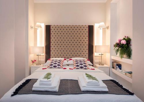 a bedroom with a large bed with two towels on it at Merchant Liston Suite in Corfu