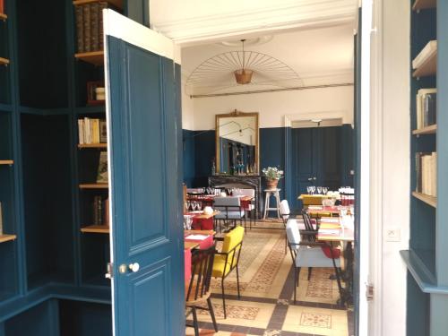 a dining room with tables and chairs and a mirror at Domaine de Keravel in Plouha