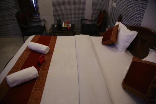 a large bed in a room with two pillows on it at Hotel City Plaza 7 in Chandīgarh