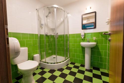 a bathroom with a toilet, sink, and bathtub at Safestay Bratislava in Bratislava