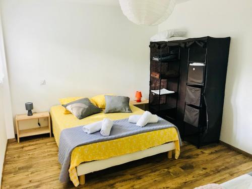 a bedroom with a bed with two pillows on it at Chez marinette in Le Cailar
