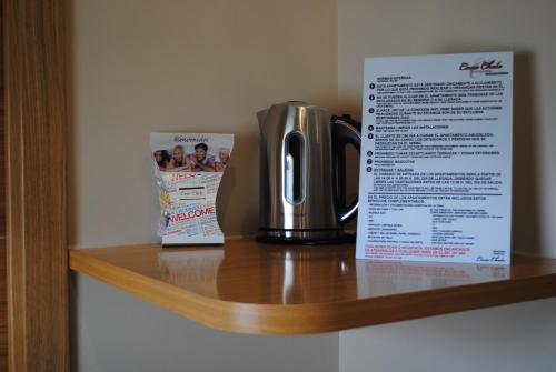 a coffee pot on a shelf next to a magazine at Casa Chelo Alojamientos Turisticos in Mazaricos