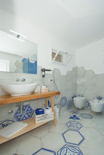 a bathroom with a sink and a toilet at Dimora Mediterranea in Mattinata