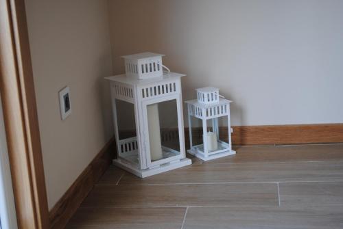 two white birdhouses sitting on the floor of a room at Casa Chelo Alojamientos Turisticos in Mazaricos