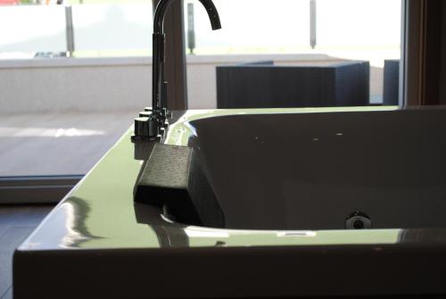 a sink with a faucet in a bathroom at Casa Chelo Alojamientos Turisticos in Mazaricos