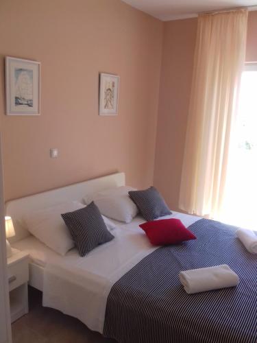 a bedroom with a bed with two pillows on it at Apartmani Goran Orebić in Orebić