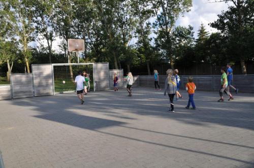 a group of people playing basketball in a park at Esbjerg Camping in Esbjerg