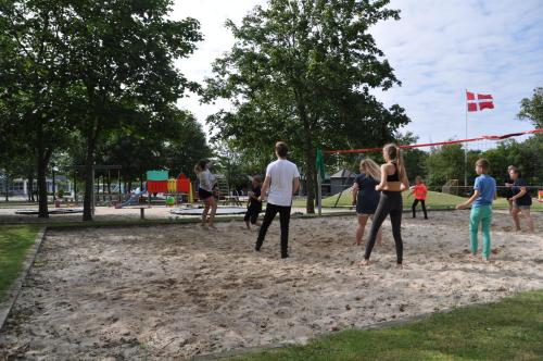 a group of people playing in the sand in a park at Esbjerg Camping in Esbjerg