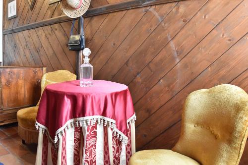 a table with a red table cloth and a bottle on it at Agriturismo Tenuta Goro Veneto in Ariano nel Polesine
