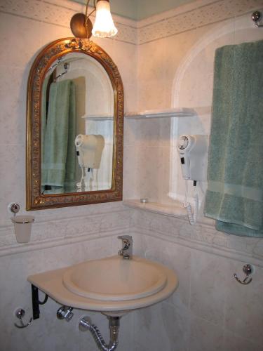 a bathroom with a sink with a mirror and a towel at Ktima Samanli in Kissos